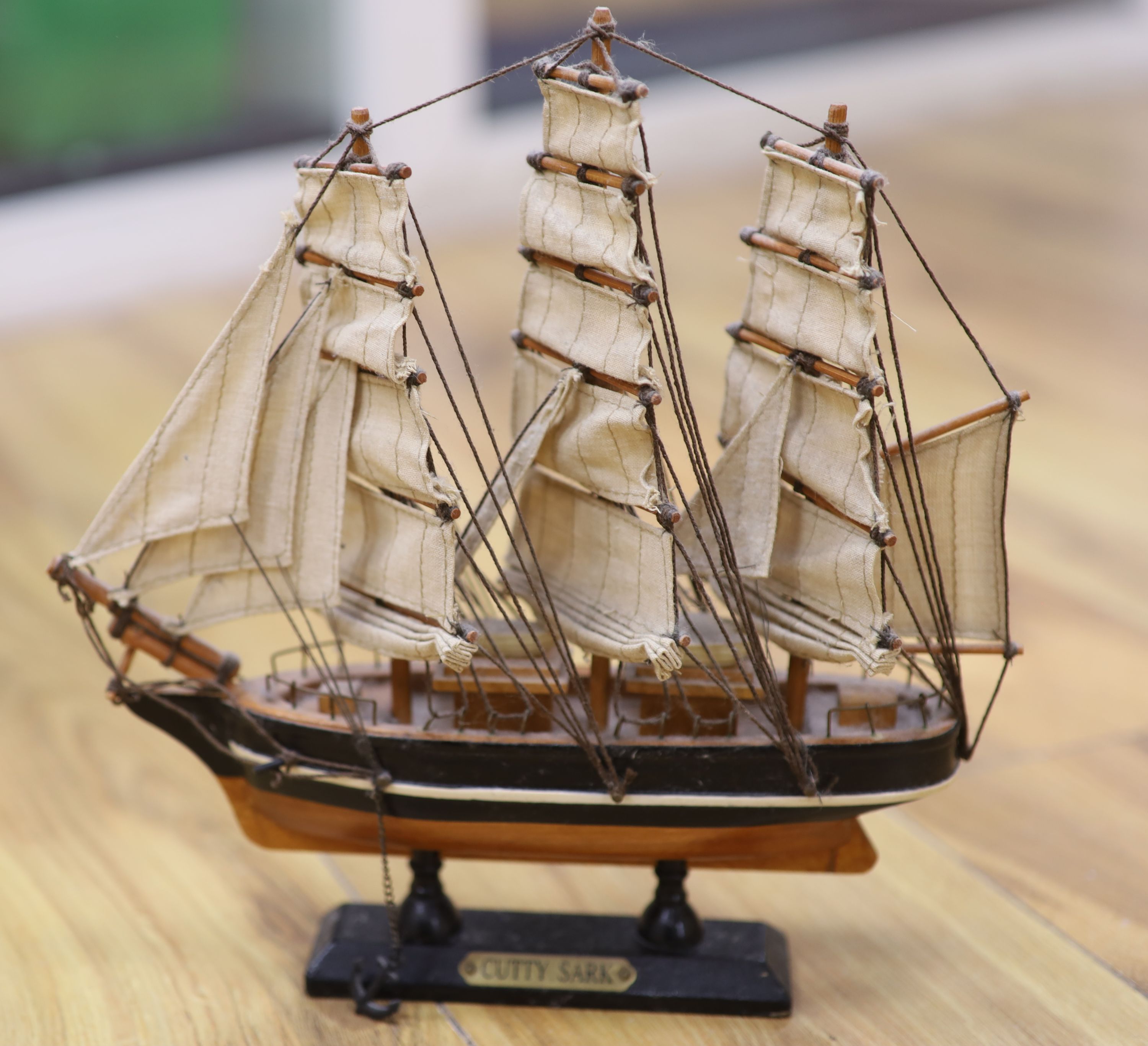 Three model ships: The Cutty Sark, The USS Constitution and Fragata, together with a carved wood Marlin